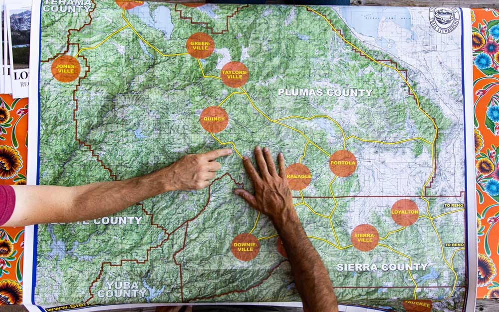 two arms pointing to center of map showing most of Plumas county and parts of Butte and Sierra counties connected by trails with several towns labeled (from north to south): Greenville, Jonesville, Taylorsville, Quincy, Portola, Graeagle, Loyalton, Sierraville, and Downieville.